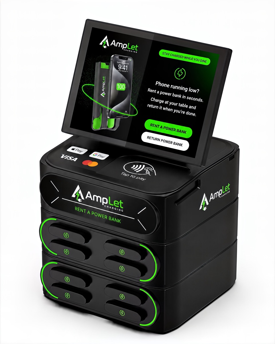 The AmpLet charging station from a side angle, showing its slim countertop profile and stacked power-bank slots